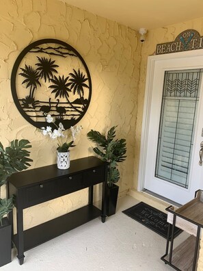 A front door with a frosted glass panel and a decorative sign above it. - 2 Mi to Beach! Pool, Hot Tub, 2 Tiki Bars, Pets OK (Bonita Springs)