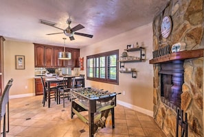 A spacious kitchen with a foosball table, wooden cabinets, and a stone fireplace. - 2 Mi to Beach! Pool, Hot Tub, 2 Tiki Bars, Pets OK (Bonita Springs)