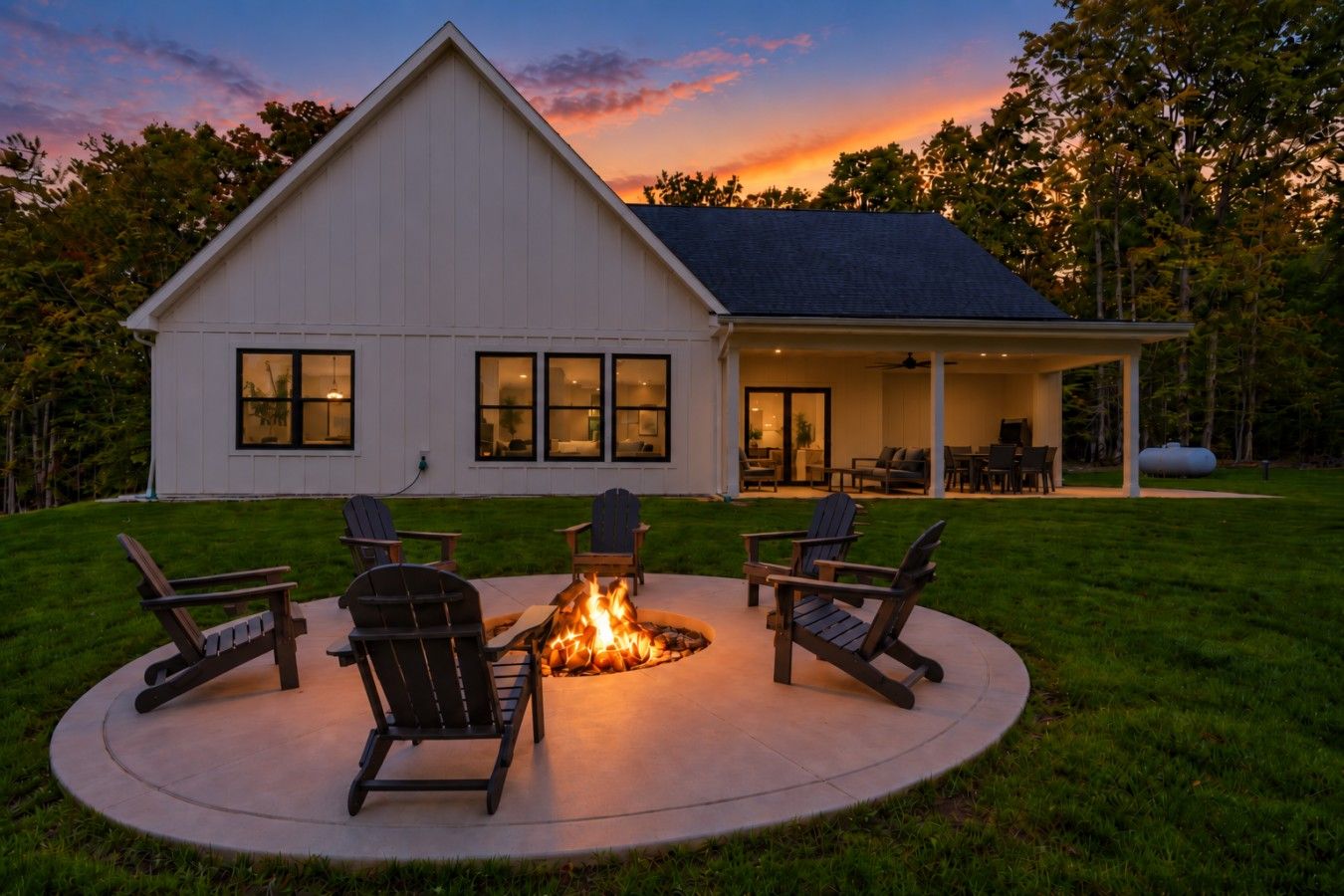 A house with a covered patio area featuring a fire pit and outdoor seating.