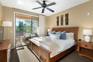 A bedroom with a bed, bedside tables, a ceiling fan, and a view of the outdoors. - Gated Condo Near Grayhawk Golf & Kierland (Scottsdale)