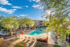 A rooftop pool area with lounge chairs and a clear blue sky. - Gated Condo Near Grayhawk Golf & Kierland (Scottsdale)