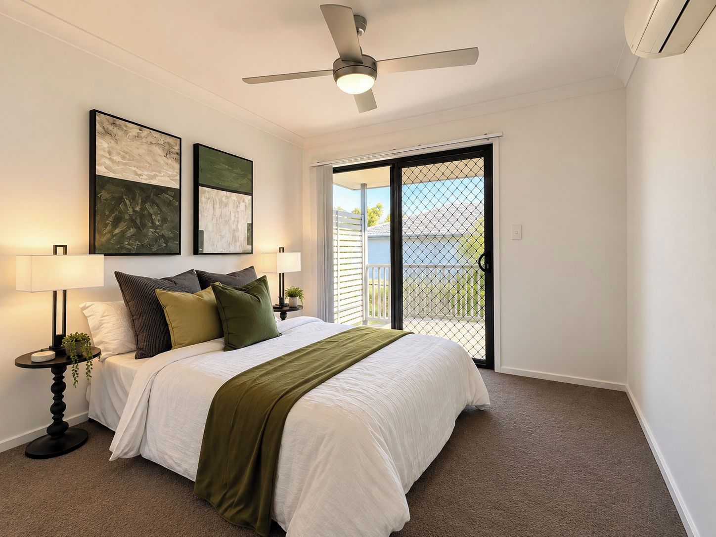A bedroom with a bed, two bedside tables, a ceiling fan, and a sliding glass door to a balcony.