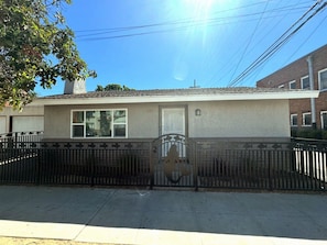 A residential building with a metal gate, a window, and a door. - Long Beach Gem - Close To Entertainment, Beaches (Long Beach)