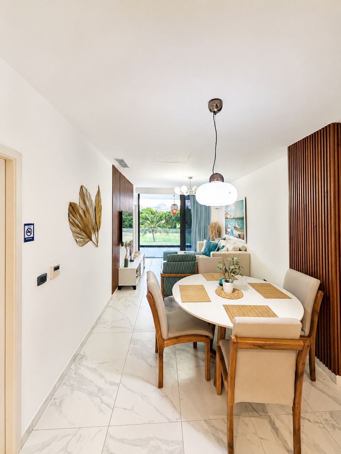 A modern dining area with a round table, chairs, and a view of the outdoors.