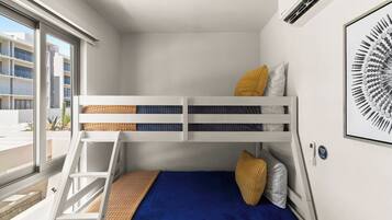 A bunk bed room with a window, a framed artwork, and a thermostat on the wall.