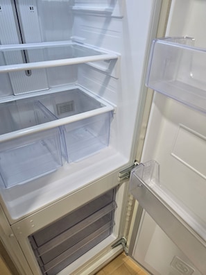 An open refrigerator with multiple transparent storage drawers. - [5 Min to Myeongdong] Twin Beds · Walk-in Closet · Separate Shower (Seoul)