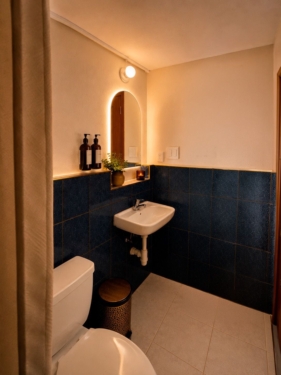 Un baño con inodoro, lavamanos y espejo.