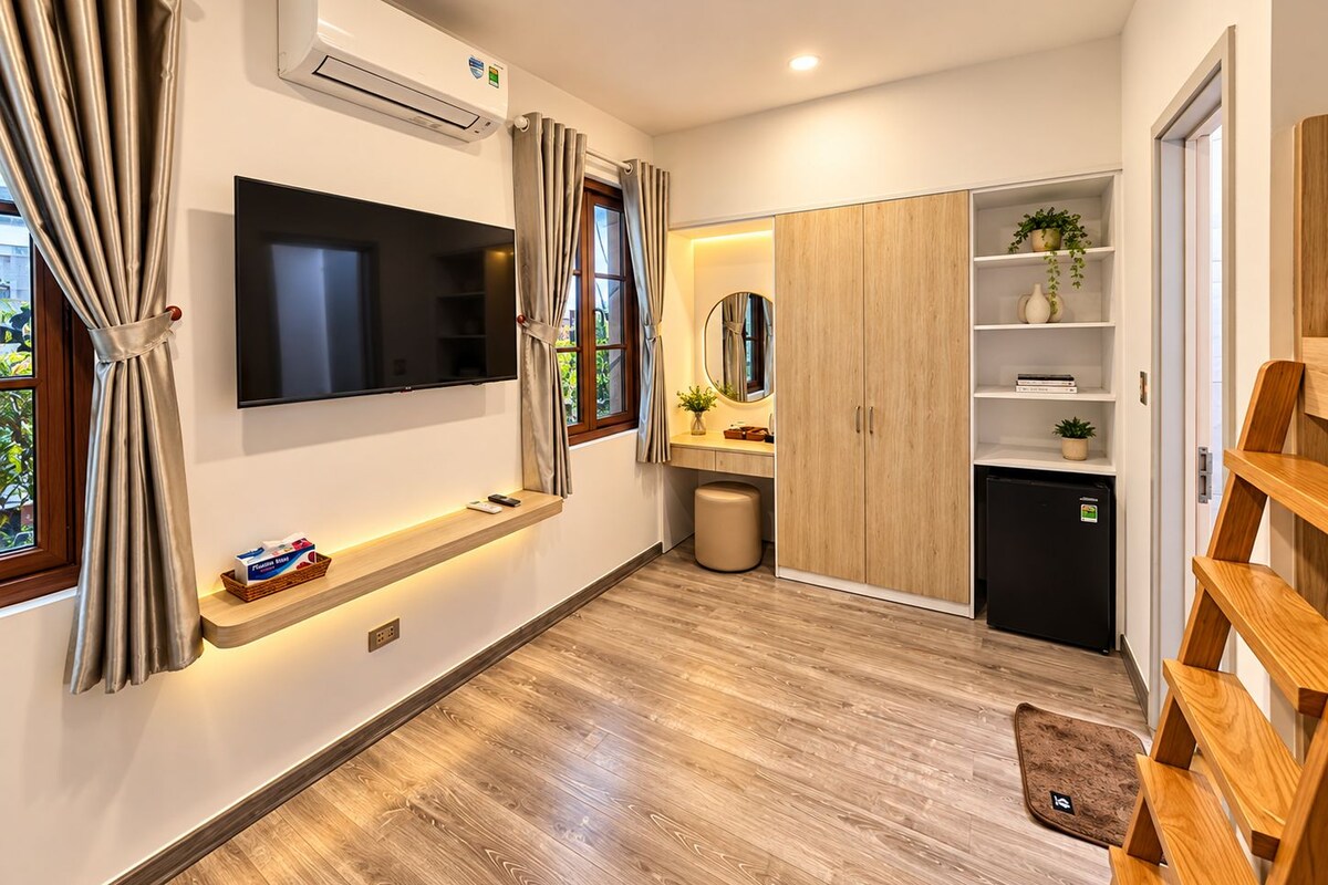 A modern bathroom with a built-in toilet, a vanity with a mirror, and a shelf with toiletries.