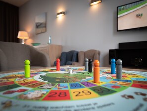 A board game with numbered spaces and player pieces on a table in a living room. - Luxury villa with private wellness (Colijnsplaat)