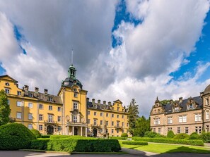 A historic building with a central tower, symmetrical architecture, and well-maintained gardens. - Holiday Apartment With 1 Bedroom (Wunstorf)