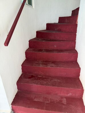 A set of red steps leading up to a landing area. - Beach Getaway in El Zapote - 3BR Home with AC (El Zapote)