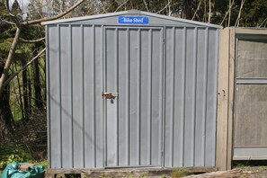 A metal shed with a 'Bike Shed' sign, a padlock, and a small window. - Cozy Stay on Coast to Coast (Kaikohe)