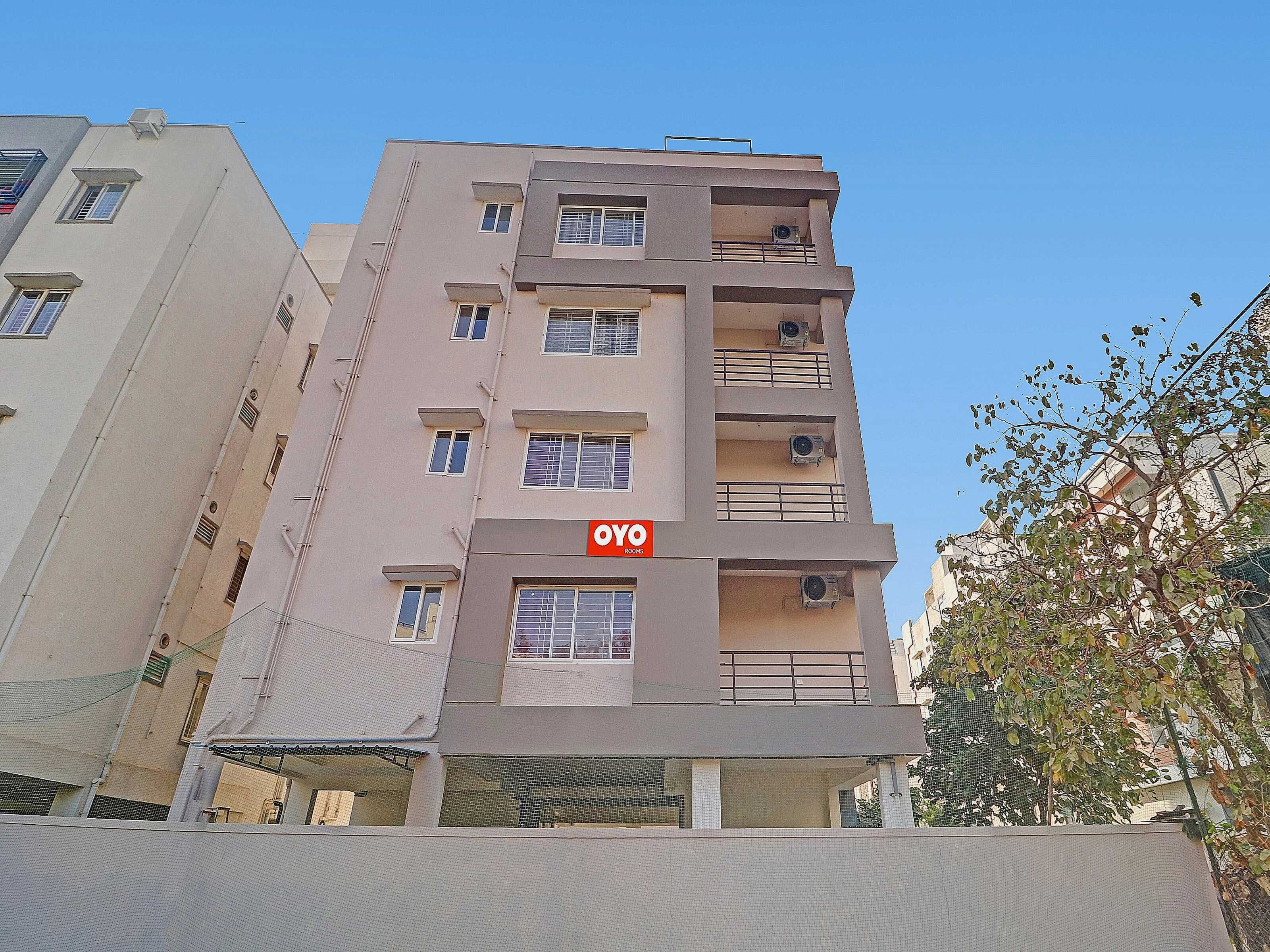 Un immeuble à plusieurs étages doté de balcons et de climatiseurs.
