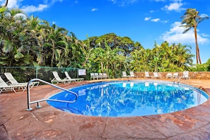 A swimming pool with lounge chairs and palm trees in the background. - Gorgeous Kaanapali 3BR with Dreamy Ocean Views (Lahaina)