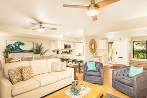 A living room with a sofa, armchairs, a coffee table, and a ceiling fan. - Gorgeous Kaanapali 3BR with Dreamy Ocean Views (Lahaina)