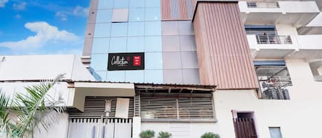 A multi-story building with a prominent sign for 'SS ENTERPRISES' and a 'Collection Hotel Star Inn' sign.