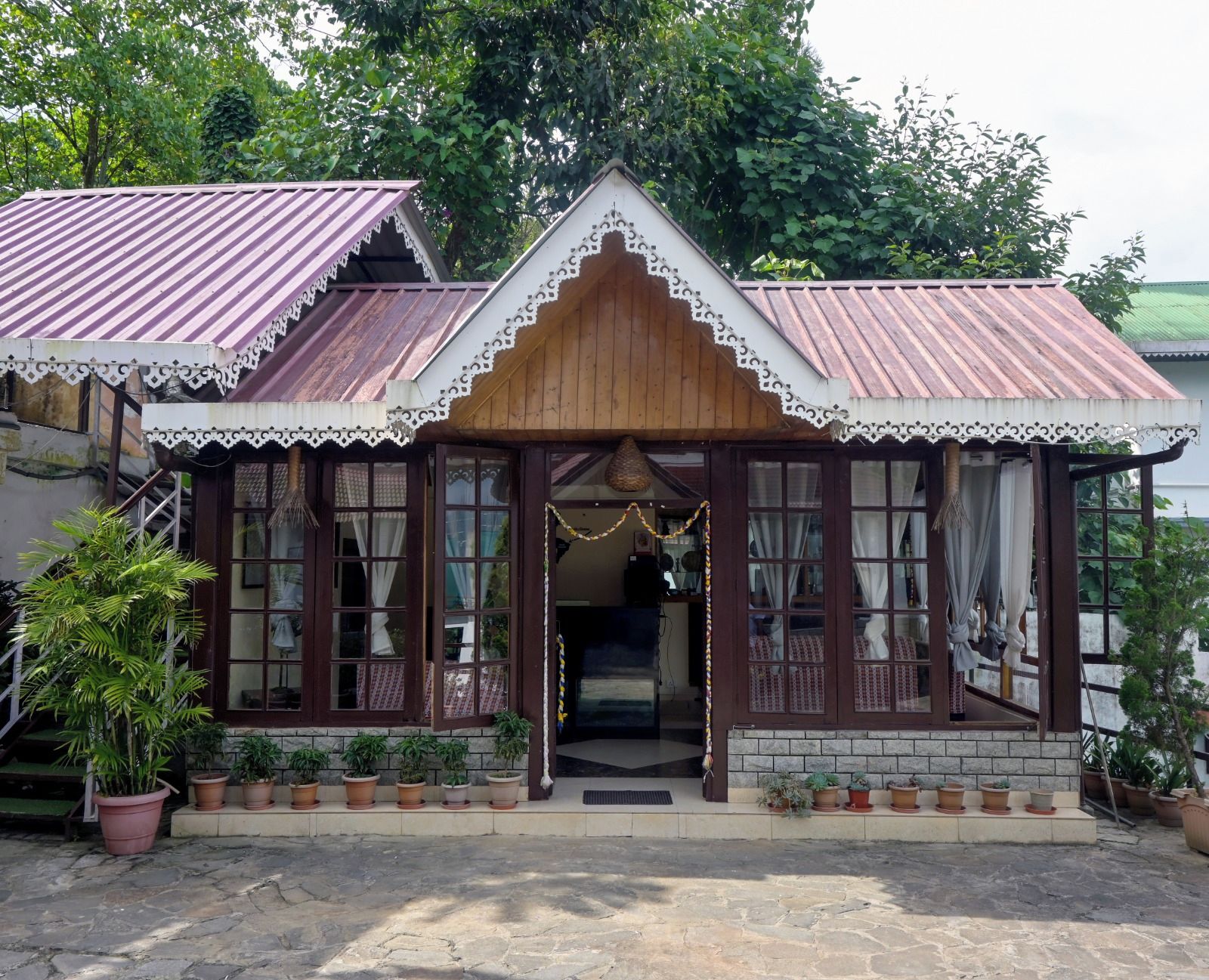 A traditional building with a wooden facade, multiple windows, and a tiled roof.