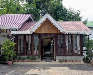 A traditional building with a wooden facade, multiple windows, and a tiled roof. - Rumtek Heritage Resort (Rumtek)
