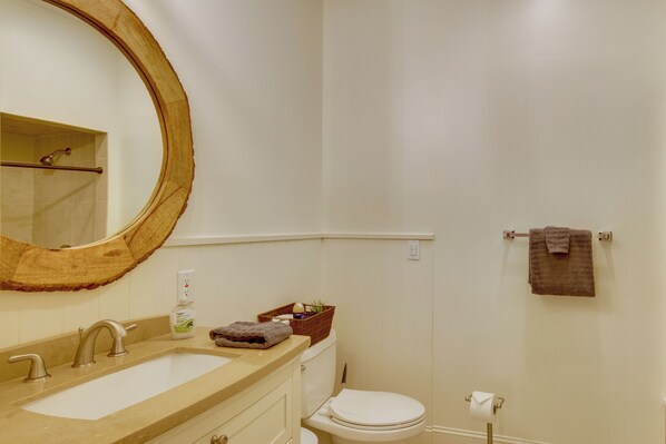 A bathroom with a round mirror, a sink, a toilet, and a towel rack. - Brevard Retreat w/ Hot Tub & Copper Soaking Tub (Brevard)