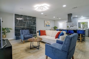 A modern living room with a white sofa, blue armchairs, and a coffee table. - Cozy Home Base Btwn Dallas & Fort Worth (Bedford)