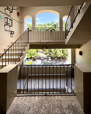 A multi-level interior with a view of a river and greenery outside. - Brisaazul Oceanfront 2BR (Puerto Vallarta)