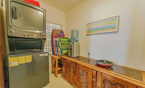 A kitchen with a refrigerator, microwave, and a water dispenser on the counter. - Brisaazul Oceanfront 2BR (Puerto Vallarta)