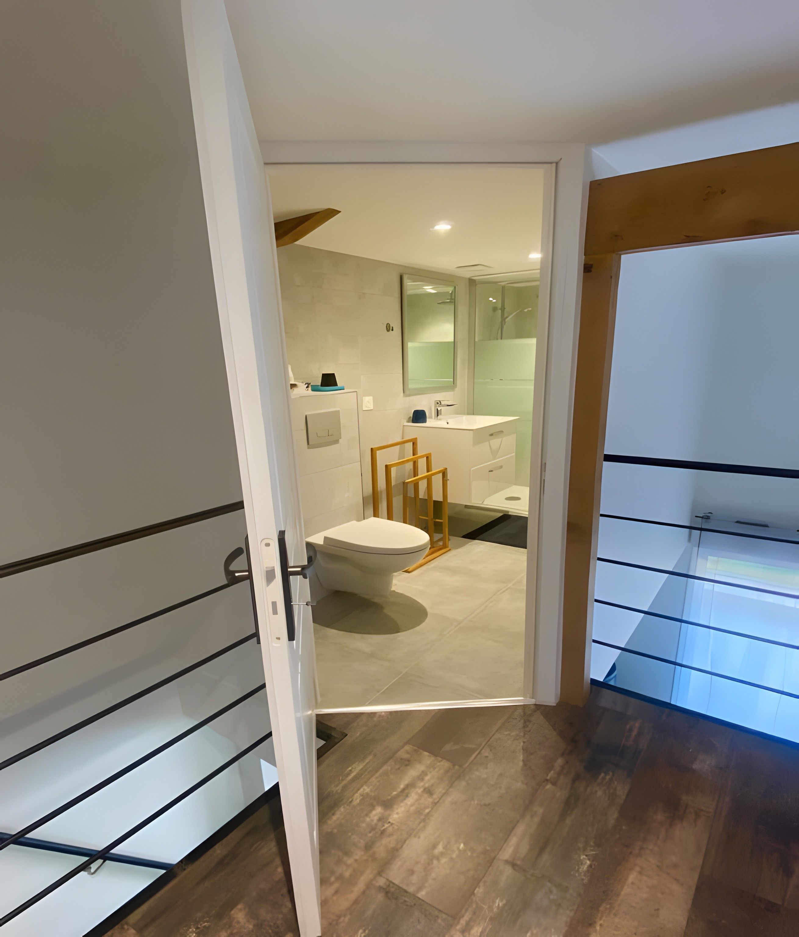 A modern bathroom with a toilet, sink, and shower.