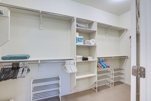 A well-organized closet with shelves, hanging space, and a foldable drying rack. - Peaceful Home w/ Resort Perks in Buckeye (Buckeye)