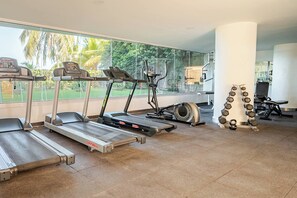 A gym with treadmills, an elliptical, and a set of dumbbells. - Comfortable Apartment near the sea in Cartagena (Cartagena)