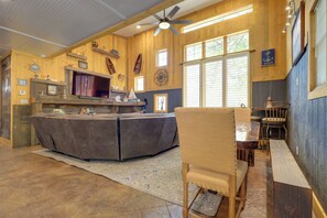 A cozy kitchen with a central island, wooden walls, and large windows. - Harbour View - Lake Cabin w/ Game Room & Fire Pit (Odessa)