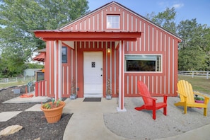 A red and white striped house with a front door, two windows, and a porch area. - Harbour View - Lake Cabin w/ Game Room & Fire Pit (Odessa)