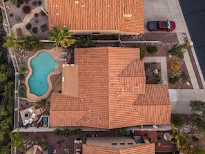 Ein Wohnhaus mit Pool, mehreren Dachabschnitten und einer Auffahrt.