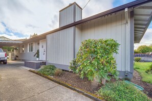 A residential building with a covered porch, a small garden with a bush, and a vehicle parked in front. - Seasonal Private Pool: Tacoma Home w/ Patio & BBQ! (Tacoma)
