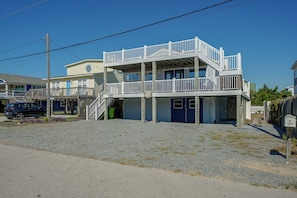 A two-story building with a balcony, a garage, and a driveway. - Steps to Beach! Topsail Island Retreat (Surf City)