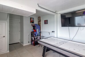 A room with a pool table, a gaming console, and a television mounted on the wall. - Game Room & Hot Tub! Bayfront Family Gem (Fort Walton Beach)