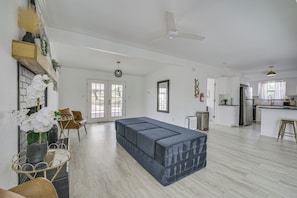 A spacious living area with a sofa, a dining table, and a kitchen in the background. - San Angelo Lake Escape: Dock & Fire Pit (San Angelo)
