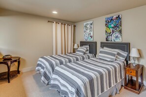 A bedroom with two beds, a nightstand, a lamp, and artwork on the walls. - Walk to Ski Slopes! Sun Valley Condo w/ Balcony (Ketchum)