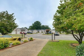A residential street with houses, parked cars, and a yellow sports car. - Private Yard & Patio! Hopewell Extended Stay (Hopewell)