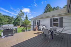 A deck with a grill, outdoor seating, and a view of a house with a fenced yard. - Hot Tub & Fenced Yard! Family Escape in Lancaster (Lancaster)