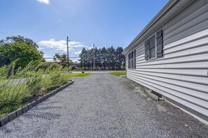 A gravel driveway leading to a white building with a sloped roof. - Hot Tub & Fenced Yard! Family Escape in Lancaster (Lancaster)