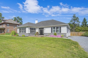 A two-story house with a front porch, a chimney, and a well-maintained lawn. - Hot Tub & Fenced Yard! Family Escape in Lancaster (Lancaster)