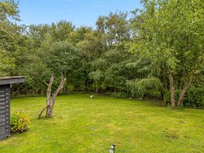 A grassy yard with trees and a small shed. - "Bennek" - 500m from the sea by Interhome (Egernsund)