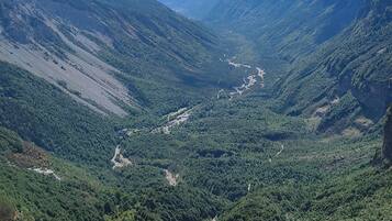 A mountainous landscape with a valley and a river.