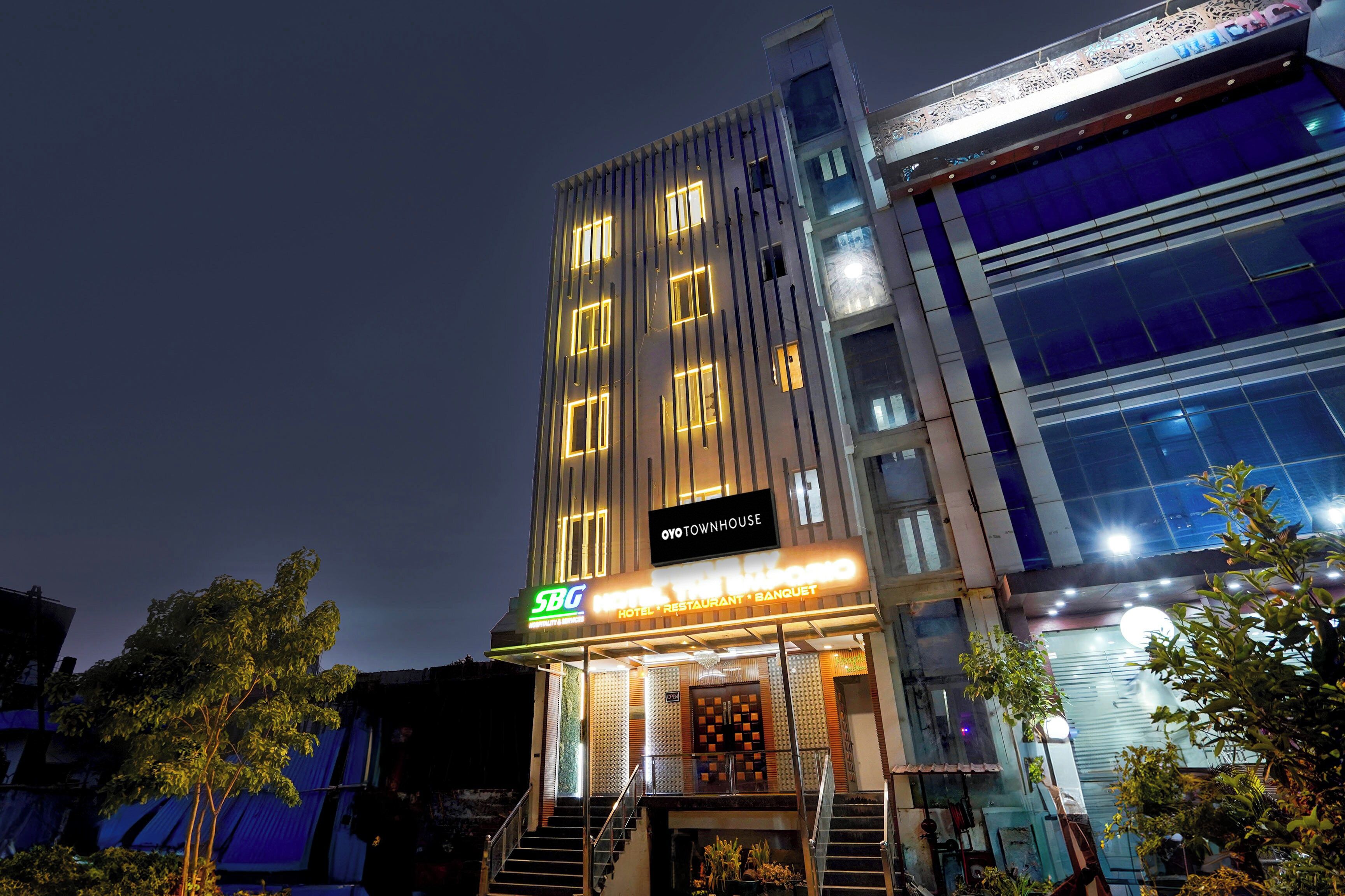 A multi-story building with a sign for 'SBB Hotel, Restaurant, Banquet' and a 'Townhouse' label.
