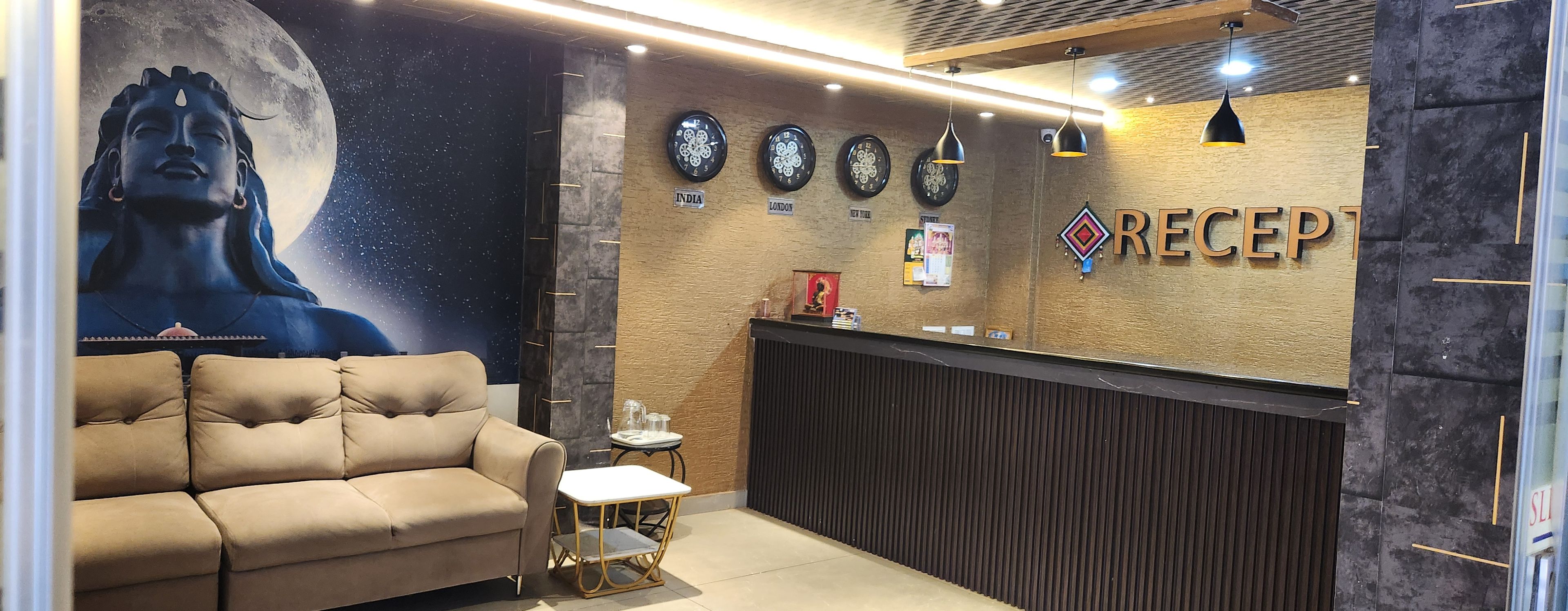 A reception area with a sofa, a counter, and clocks labeled with locations.