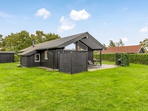 A small wooden house with a sloped roof and a fenced yard. - "Ellanor" - 100m from the sea by Interhome (Broager)