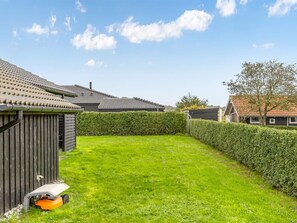 A well-maintained backyard with a lawn, a wooden shed, and a hedge. - "Ellanor" - 100m from the sea by Interhome (Broager)