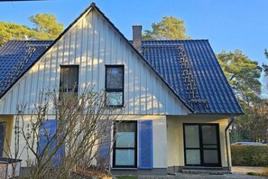 A two-story house with a sloped roof, a chimney, and a small window. - Holiday home with 2 bedrooms (Ostseebad Prerow)