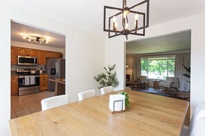A modern kitchen with stainless steel appliances, a dining area with a wooden table, and a living room with a view. - A cozy getaway in a convenient location, offering a comfortable home base for exploring the city and surrounding Montana area. Enjoy a relaxing stay with easy access to local shops, dining, outdoor recreation, and all Missoula has to offer. (Missoula)