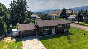 A two-story house with a garage, a driveway, and a lawn.